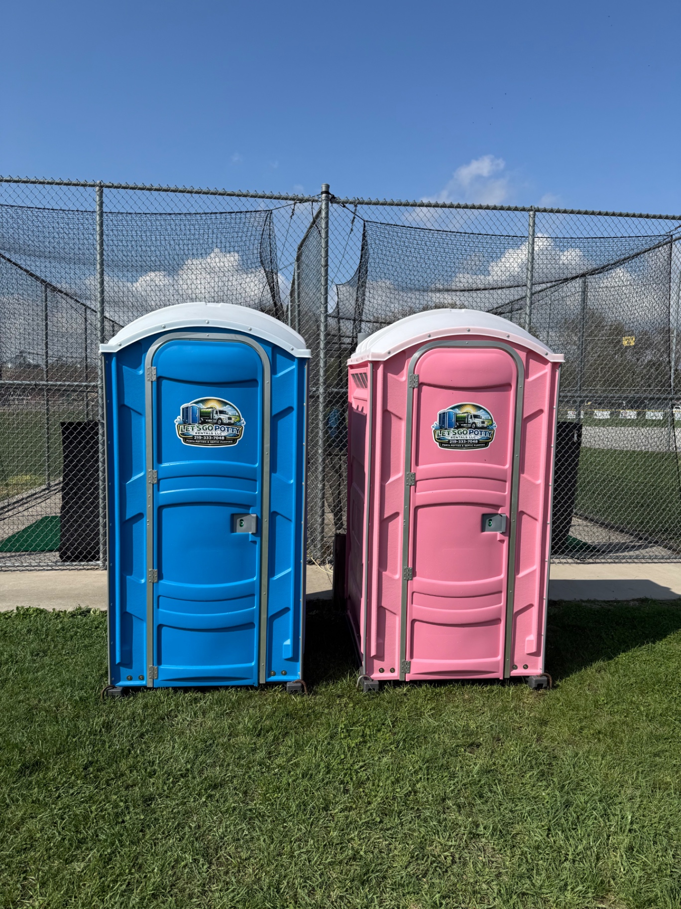 Blue and pink Let's Go Potty Rentals porta potties set up at the Wheatfield Little League ball fields at Wheatfield Elementary in Wheatfield, Indiana